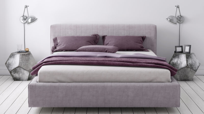 clean made mattress with purple sheets and modern geometric nightstands with lamps