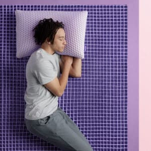 Man sleeping on a Purple Mattresses