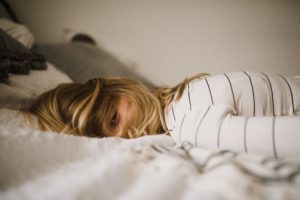 image of woman lying sideways in bed unable to sleep