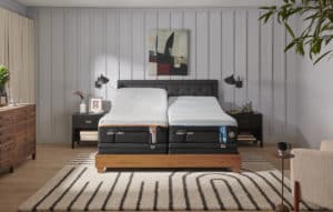 TempurPedic Luxe Adapt Firm bed staged in a room.